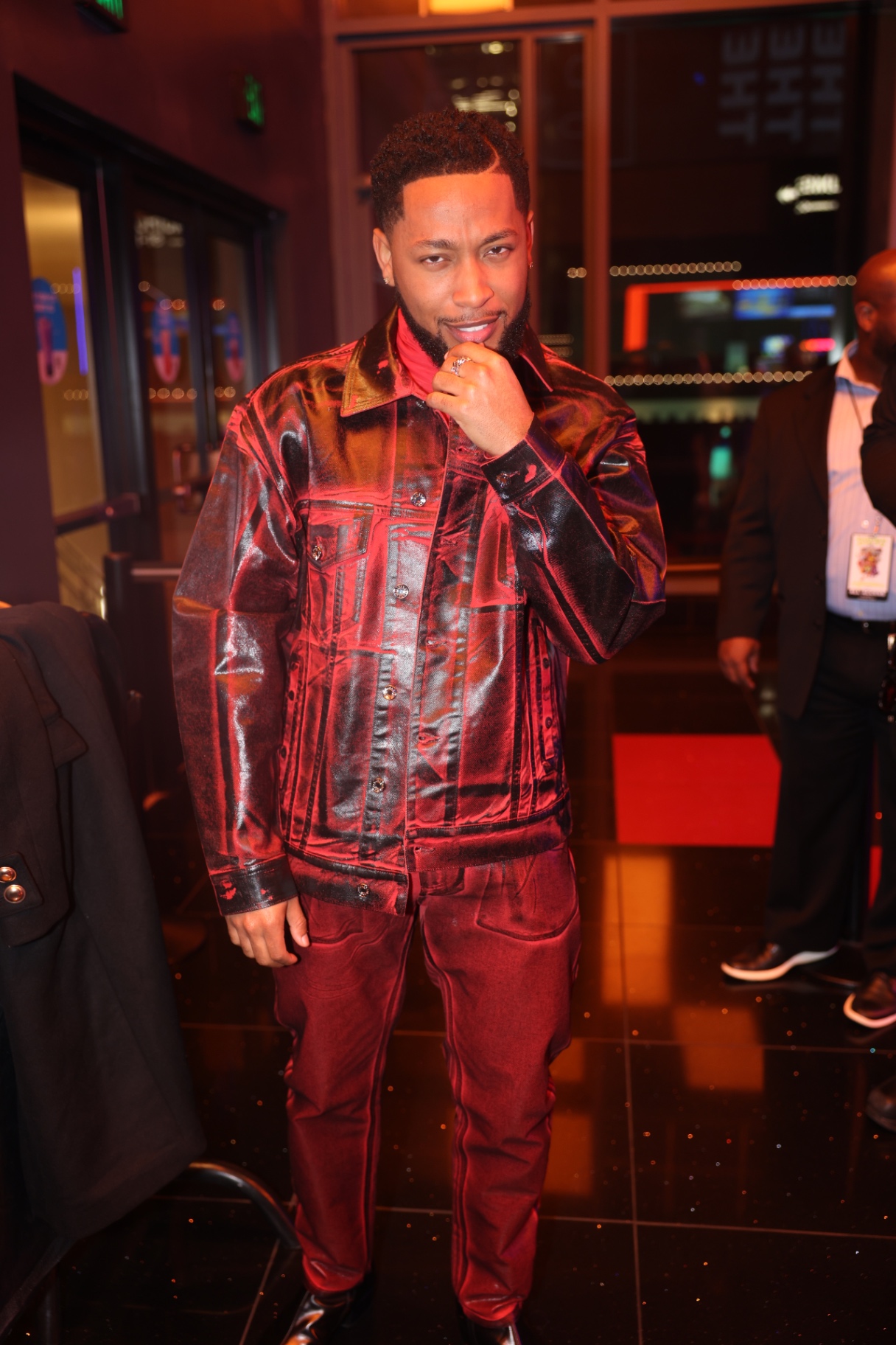 Red carpet arrival in a metallic red denim set