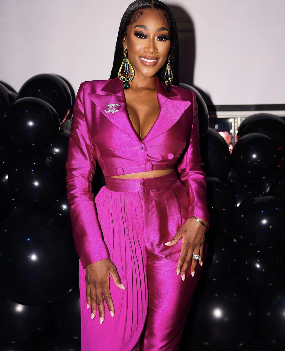 Portrait in a pink satin suit at a private celebration
