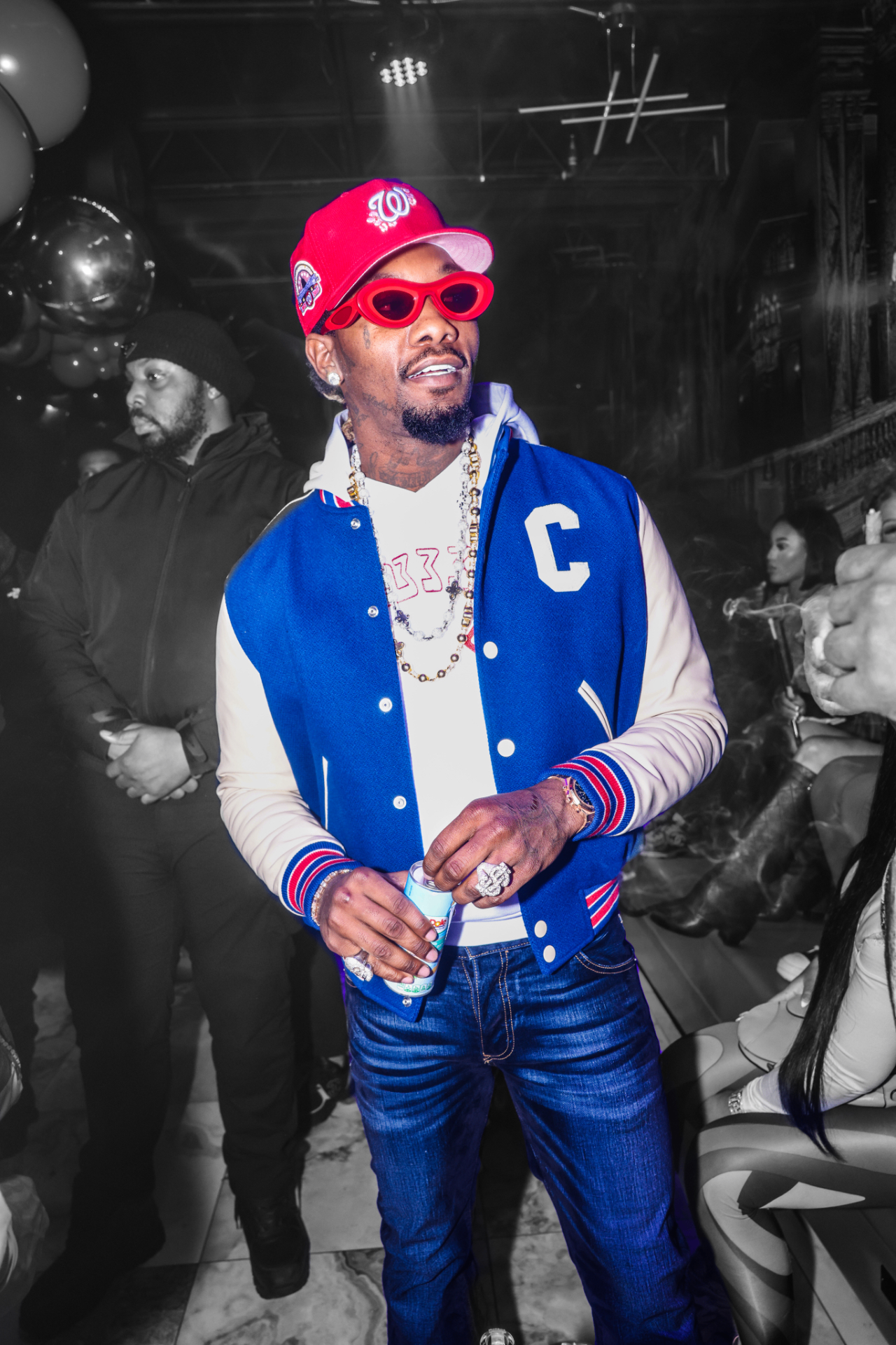 Artist in a blue varsity jacket at an Atlanta party