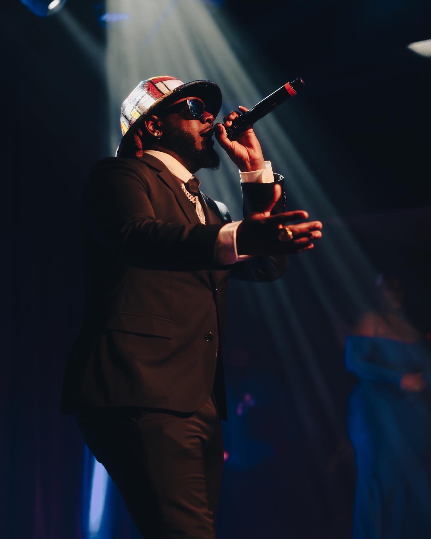 Performer on stage under spotlights