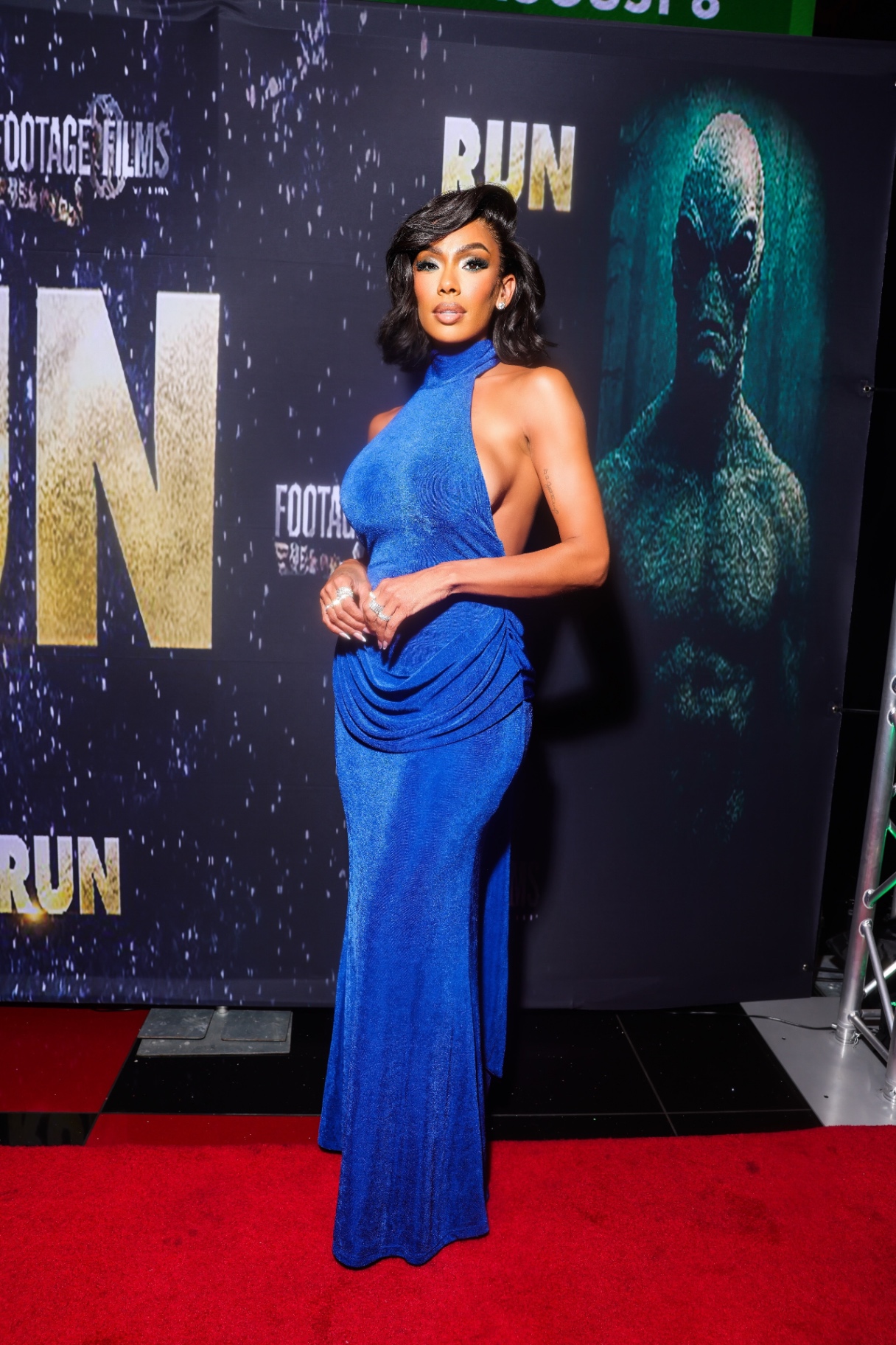 Blue gown red carpet portrait at the RUN premiere